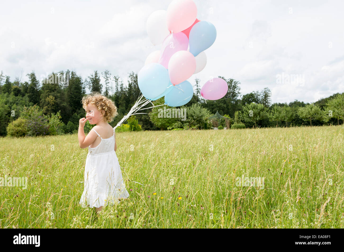 Girl in white dress holding hi-res stock photography and images - Alamy