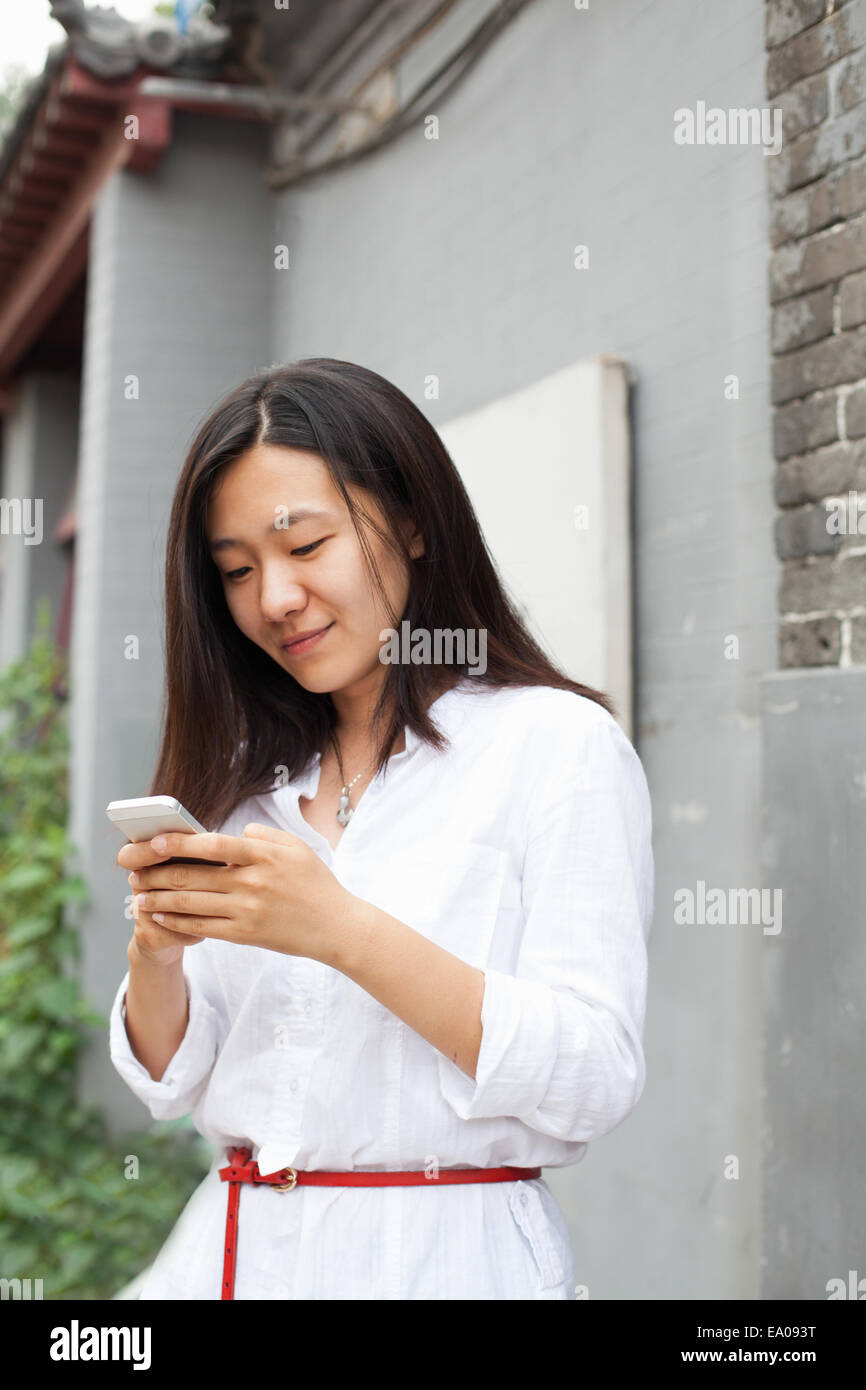 Young woman looking at mobile phone Stock Photo