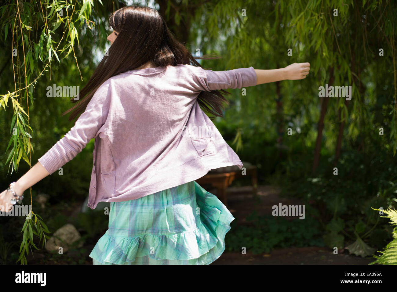 Woman dancing in garden Stock Photo Alamy