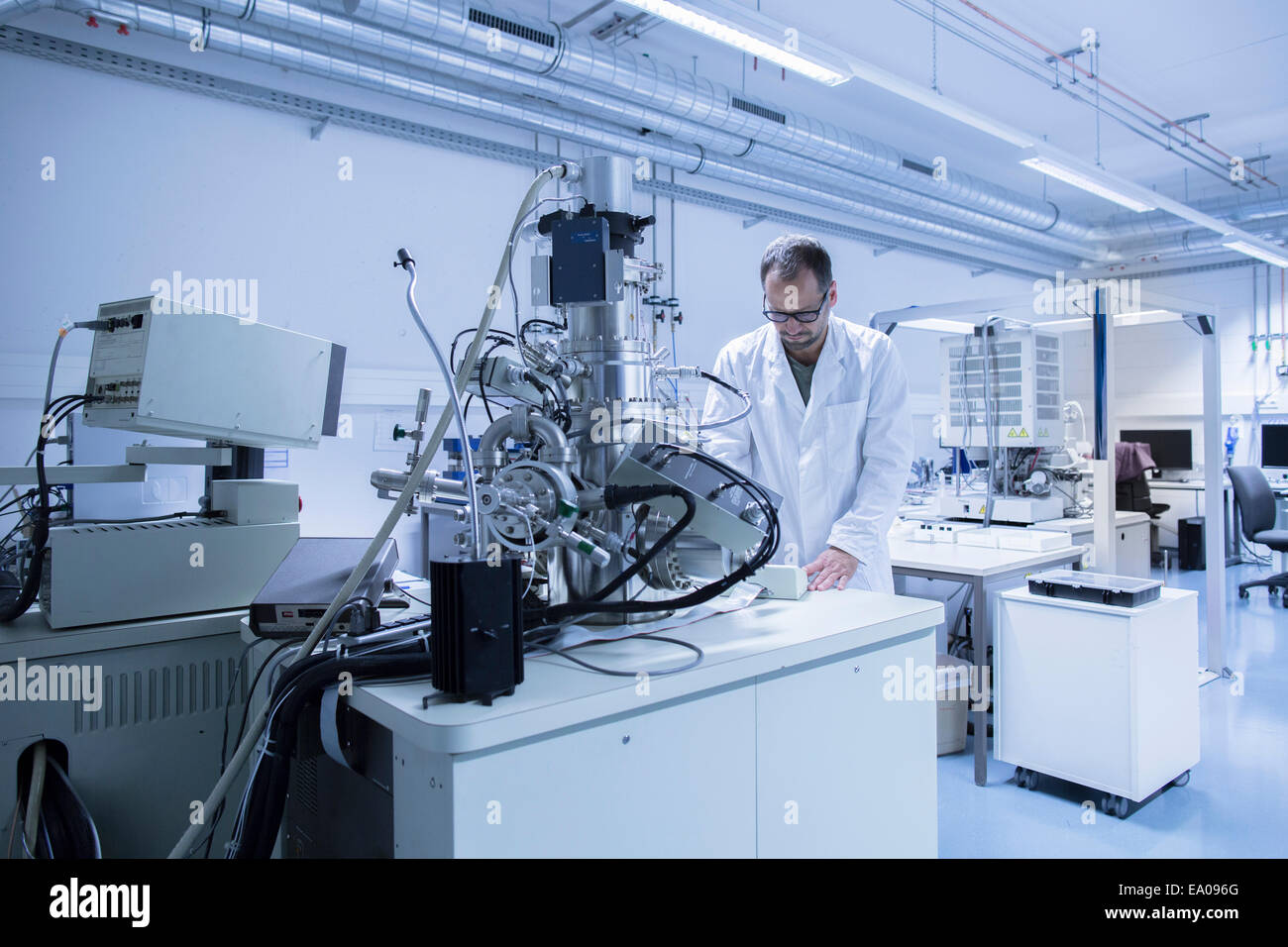 Manufacturing Lab Assistant Lab assistant working on equipment Stock Photo - Alamy