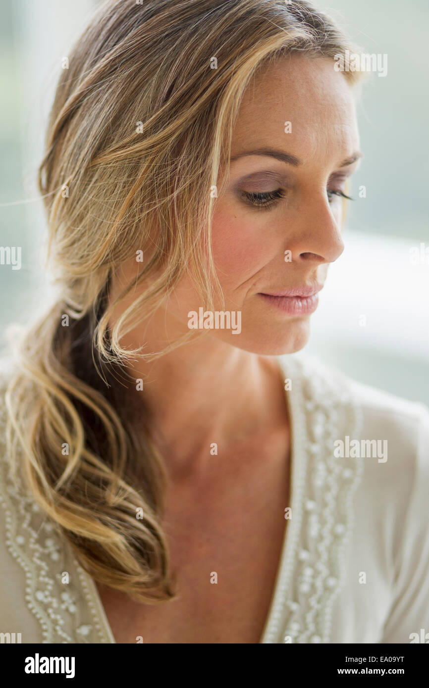 Mature blonde woman looking down, portrait Stock Photo