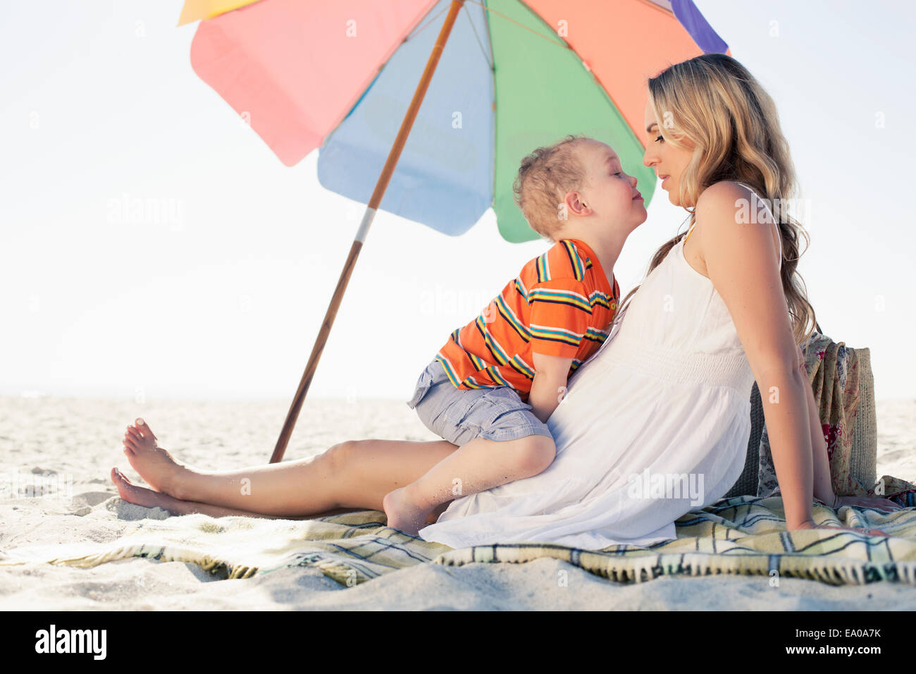 Mid adult mother and son picnic blanket at beach, Cape Town, Western