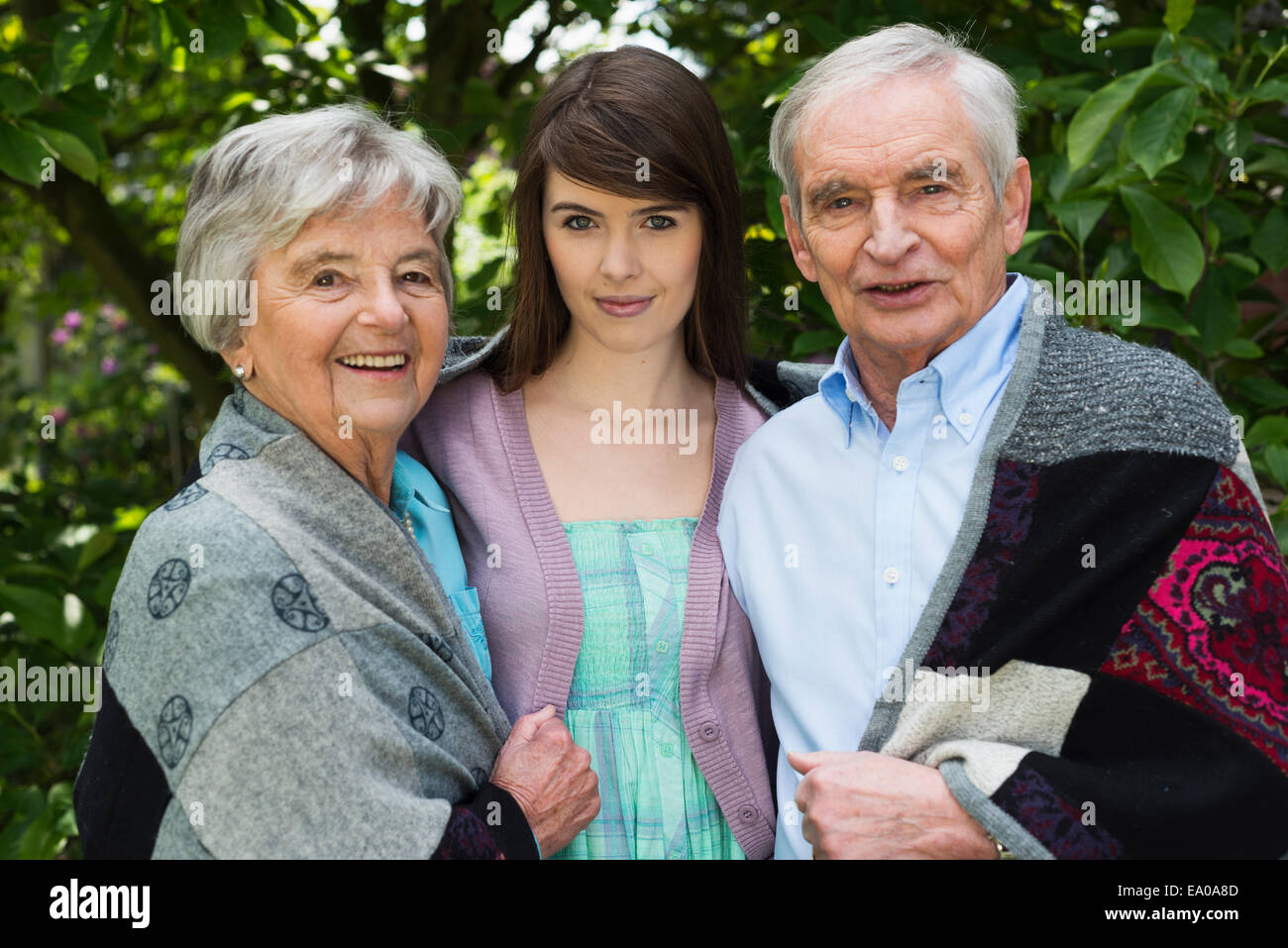 Grandparents and granddaughter in garden Stock Photo