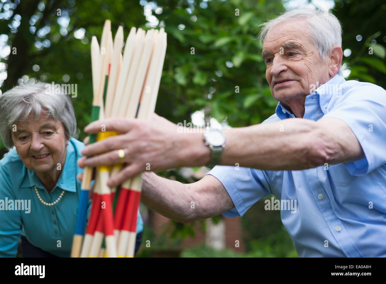 Grandfather and grandmother with giant pick up sticks Stock Photo