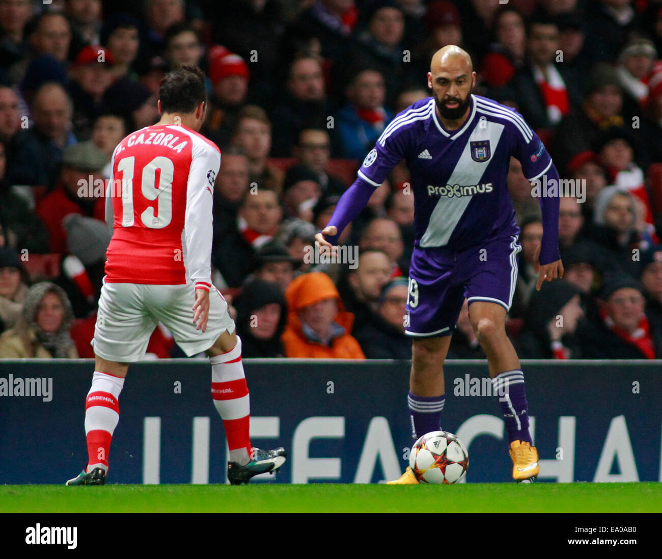 LONDON, ENGLAND - NOV 04: Arsenal's Santi Cazorla and Nathan Kabasele of Anderlecht during the UEFA Champions League match between Arsenal from England and Anderlecht from Belgium played at The Emirates Stadium, on November 04, 2014 in London, England. (Photo by Mitchell Gunn/ESPA) Stock Photo