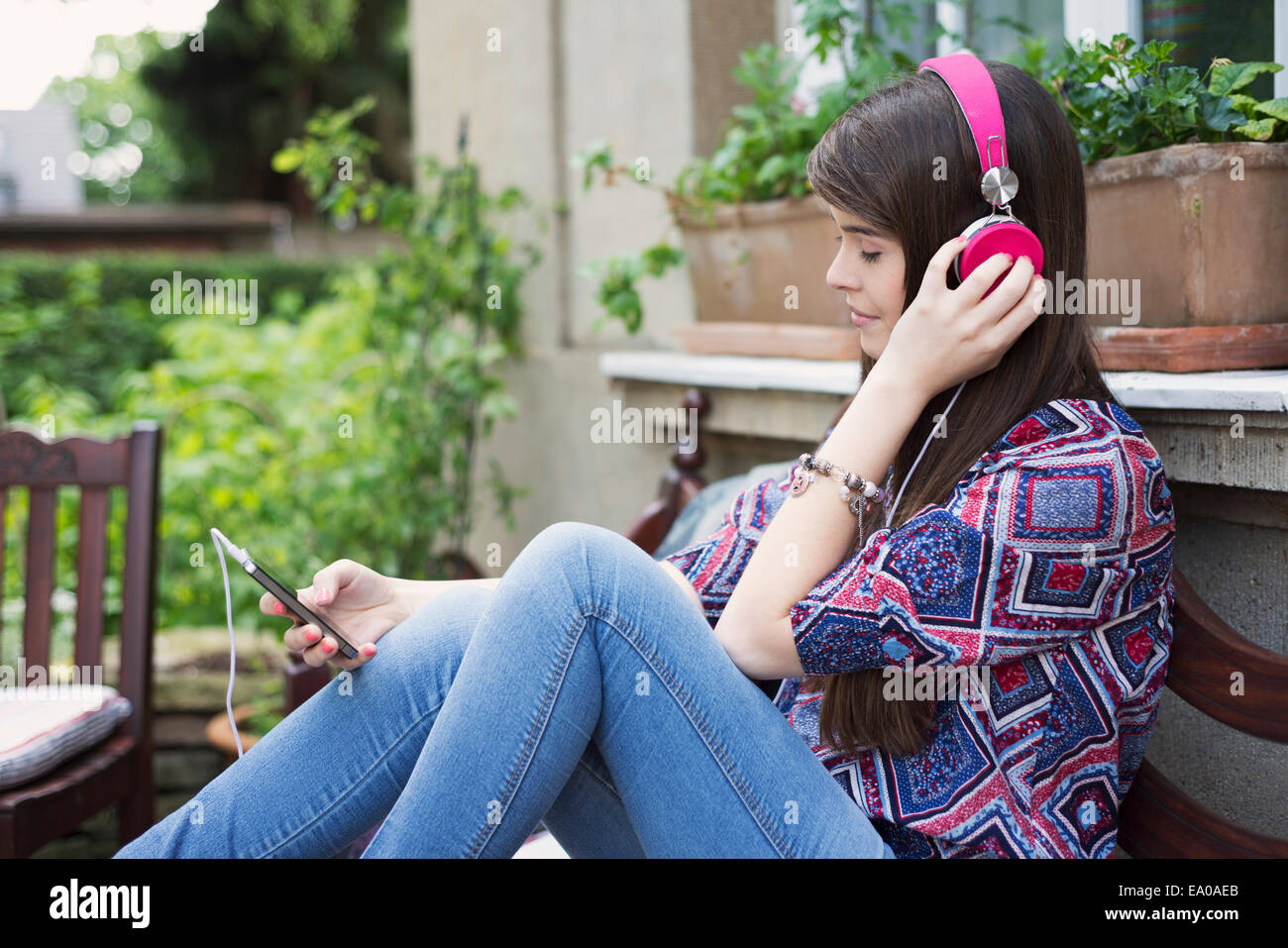 Young woman wearing headphones, listening to music Stock Photo