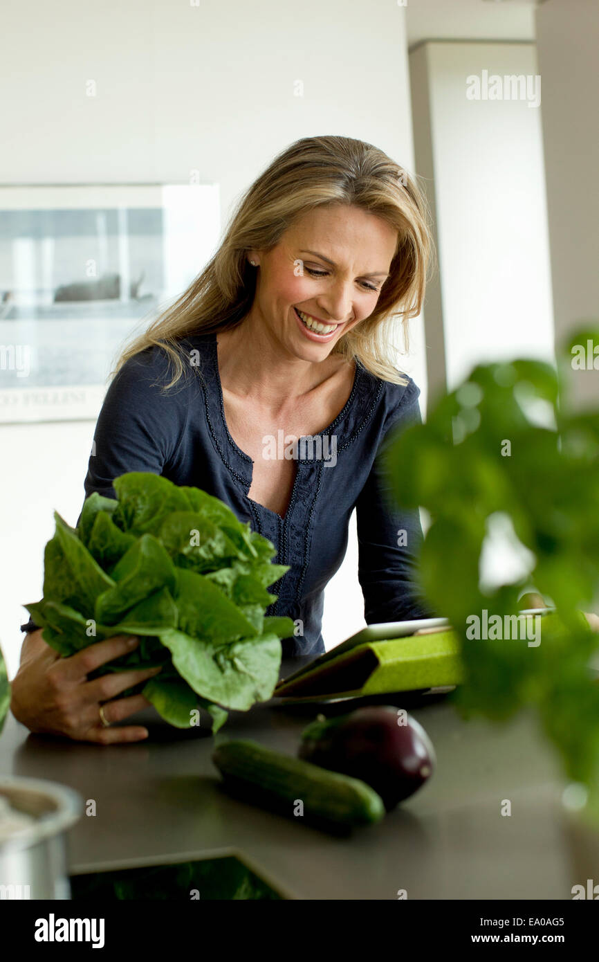Mature woman holding lettuce Stock Photo
