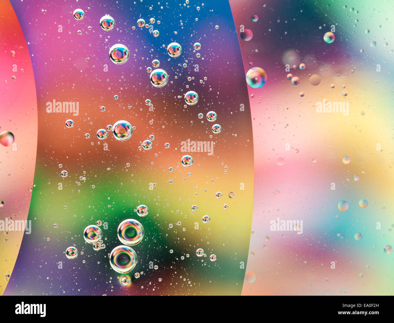 macro of oil drops on water with colorful background Stock Photo - Alamy