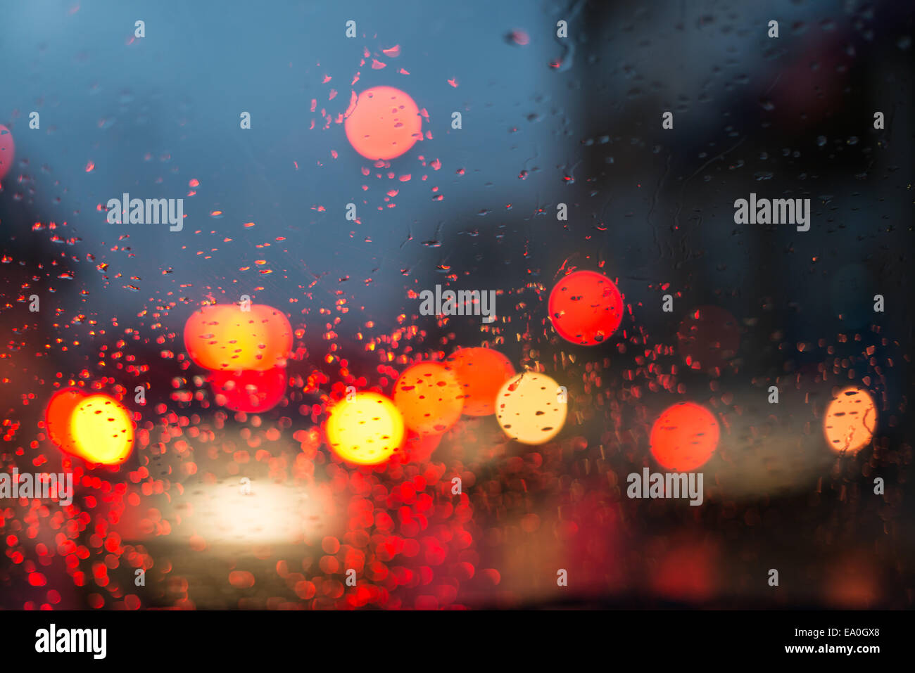 Night driving in the rain through the windshield watching the red lights Stock Photo