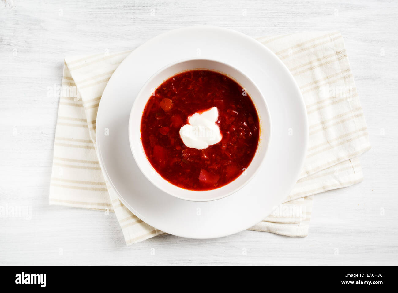 Russian soup borsch in white bowl served on white table Stock Photo