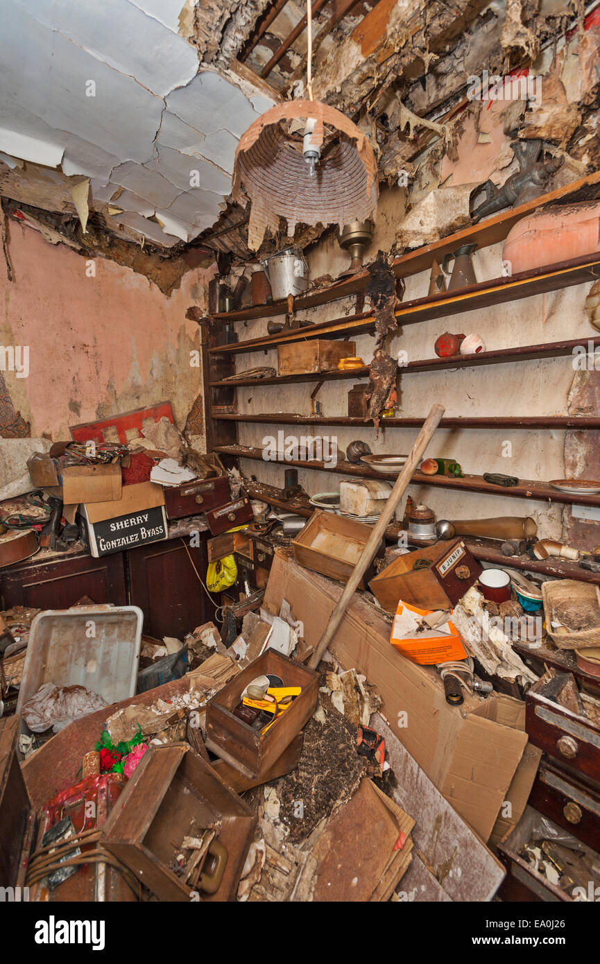 A derelict storeroom in an abandoned and collapsing house Stock Photo