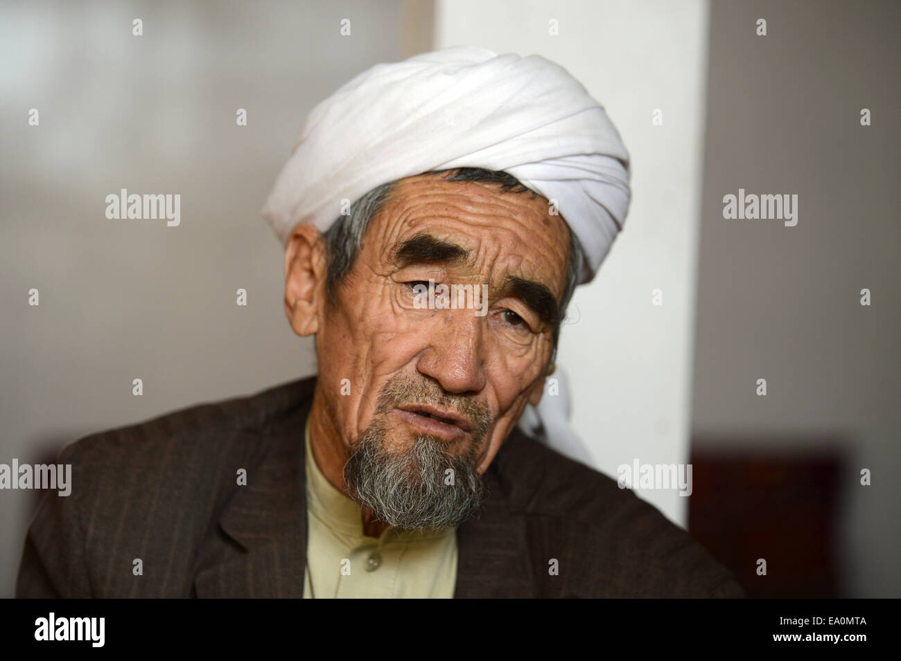 Bamian, Afghanistan. 24th Oct, 2014. The Afghani cleric Sadschad Mohsini in his home in Bamian, Afghanistan, 24 October 2014. Mohsini finds that social media is a useful tool to spread faith. In 2008 he caused an uproar after photos of him shaking the hand of the wife of then US President, Laura Bush, were shared around the world. Today the 67-year old uses social media to advise young people in matters of faith and religion. His son taught him how to navigate search engines and explained how Facebook works. Photo: Subel Bhandari/dpa/Alamy Live News Stock Photo