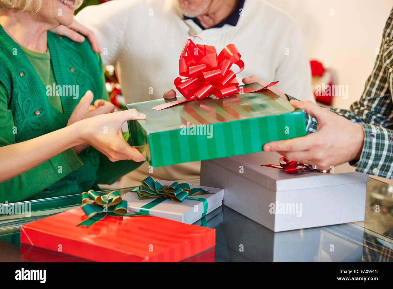 Hands offering different gifts for christmas eve Stock Photo
