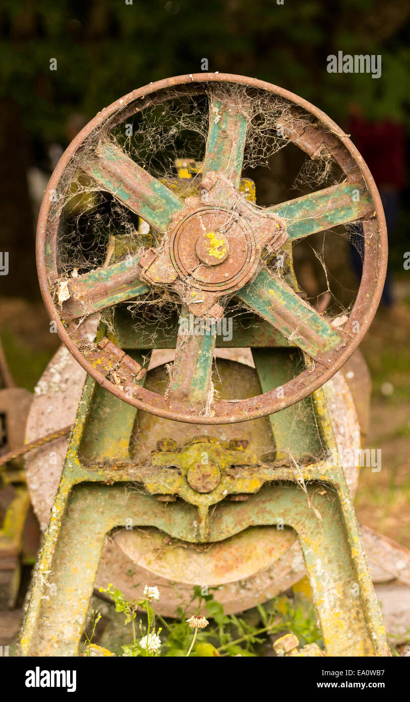 Rusty farm machinery with flywheel Stock Photo