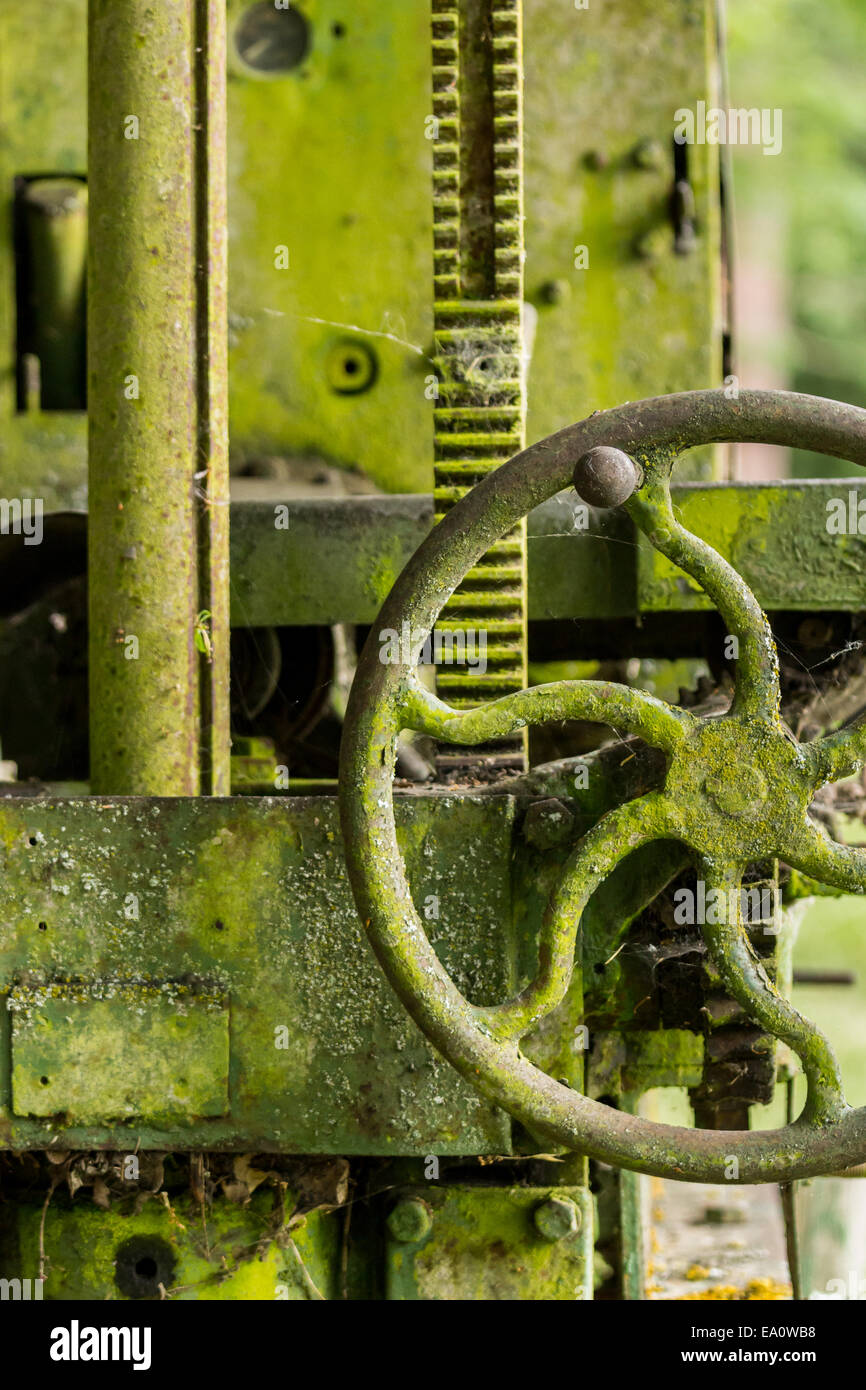 Moss covered farm machinery with handle Stock Photo
