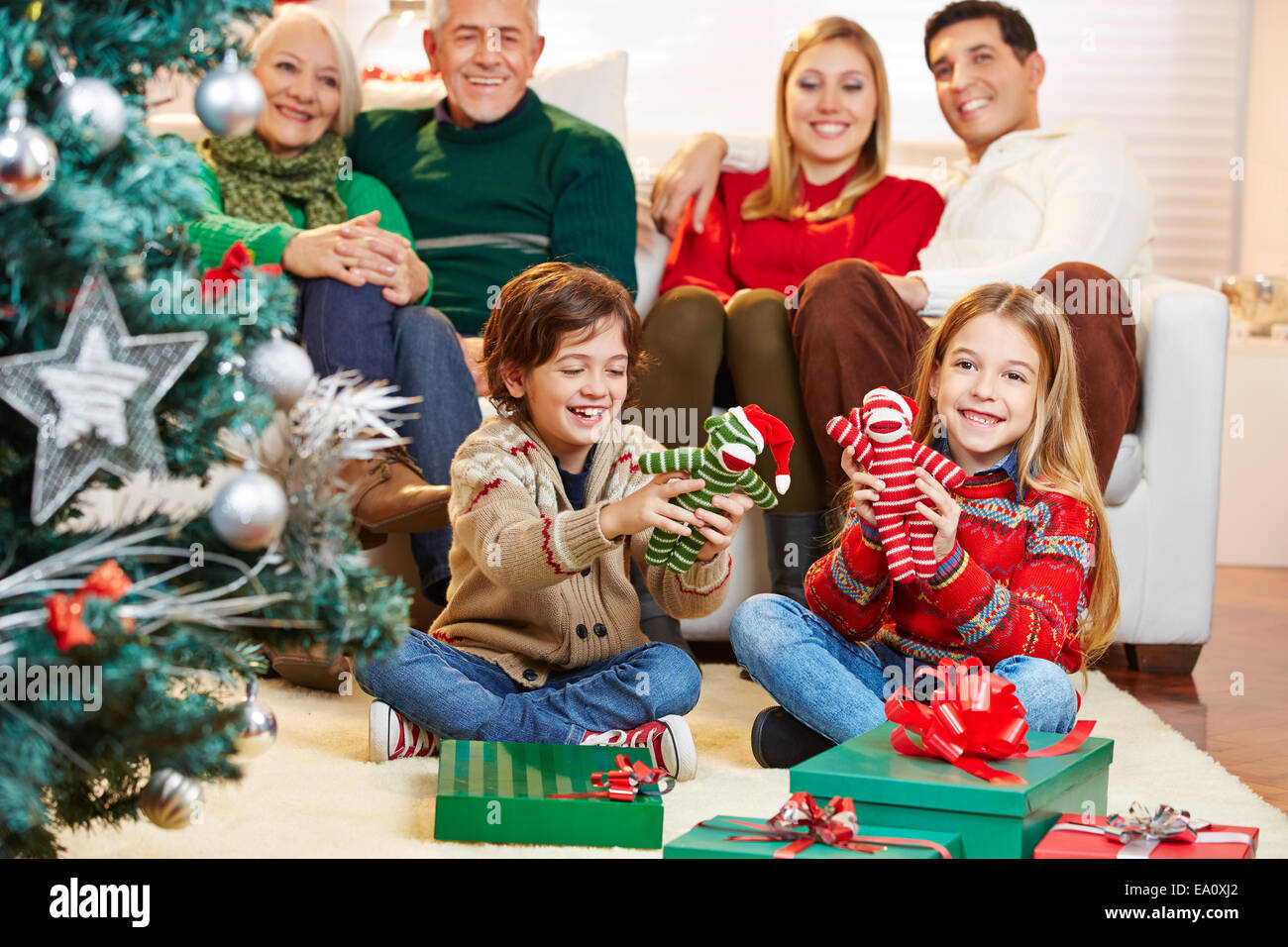 Two children are happy with their gifts at christmas eve with the