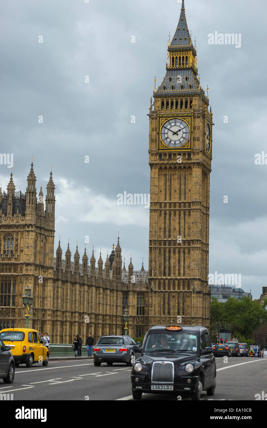 London, England: Black cab passing Big Ben and the Houses of Parliament in central London Stock Photo