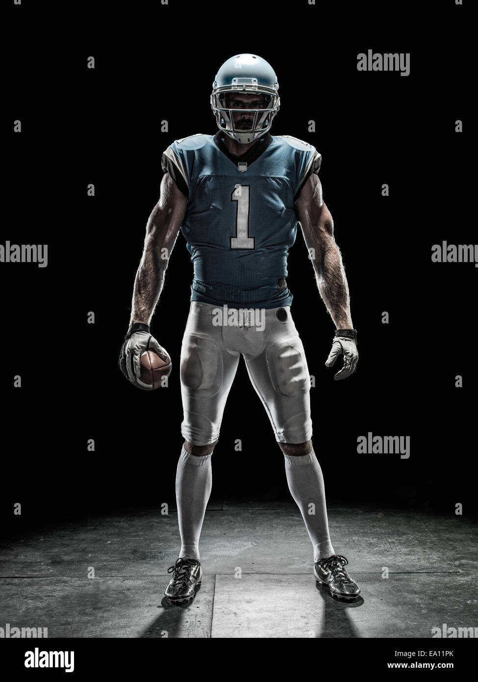 Football player holding ball Stock Photo Alamy