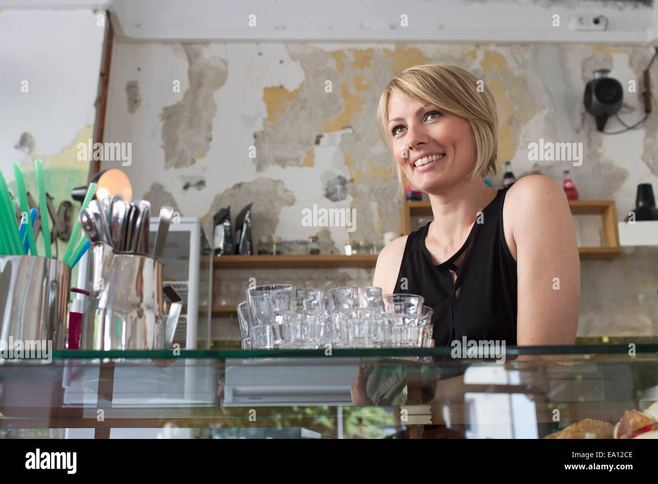 Mid adult woman working in cafe Stock Photo