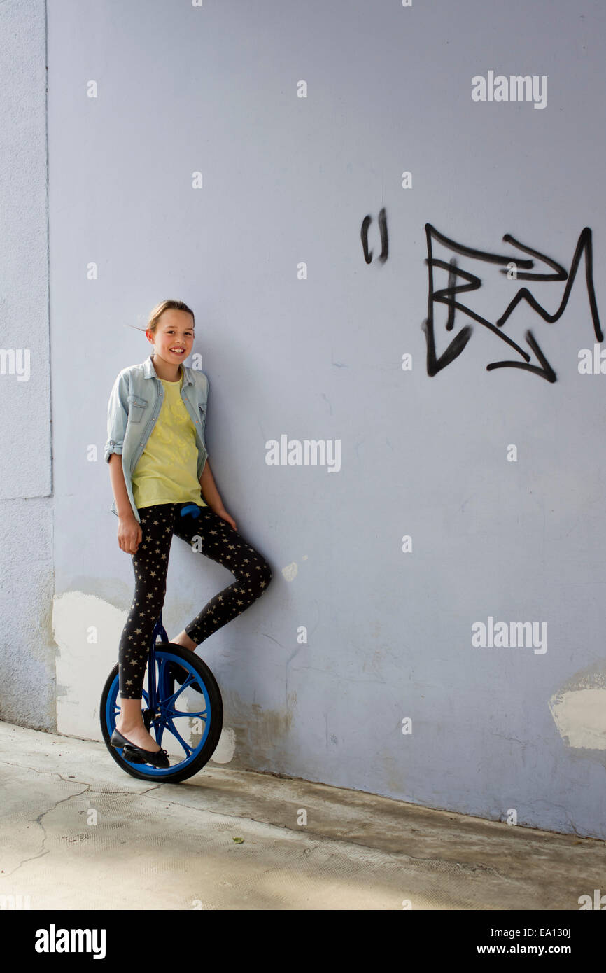 Teenage girl on unicycle, portrait Stock Photo