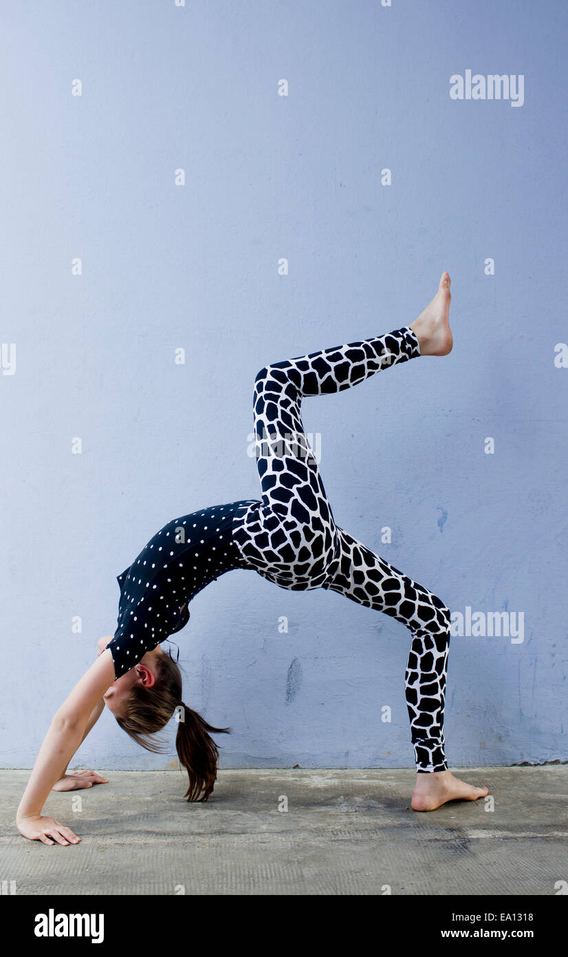 Teenage girl doing backwards bend Stock Photo