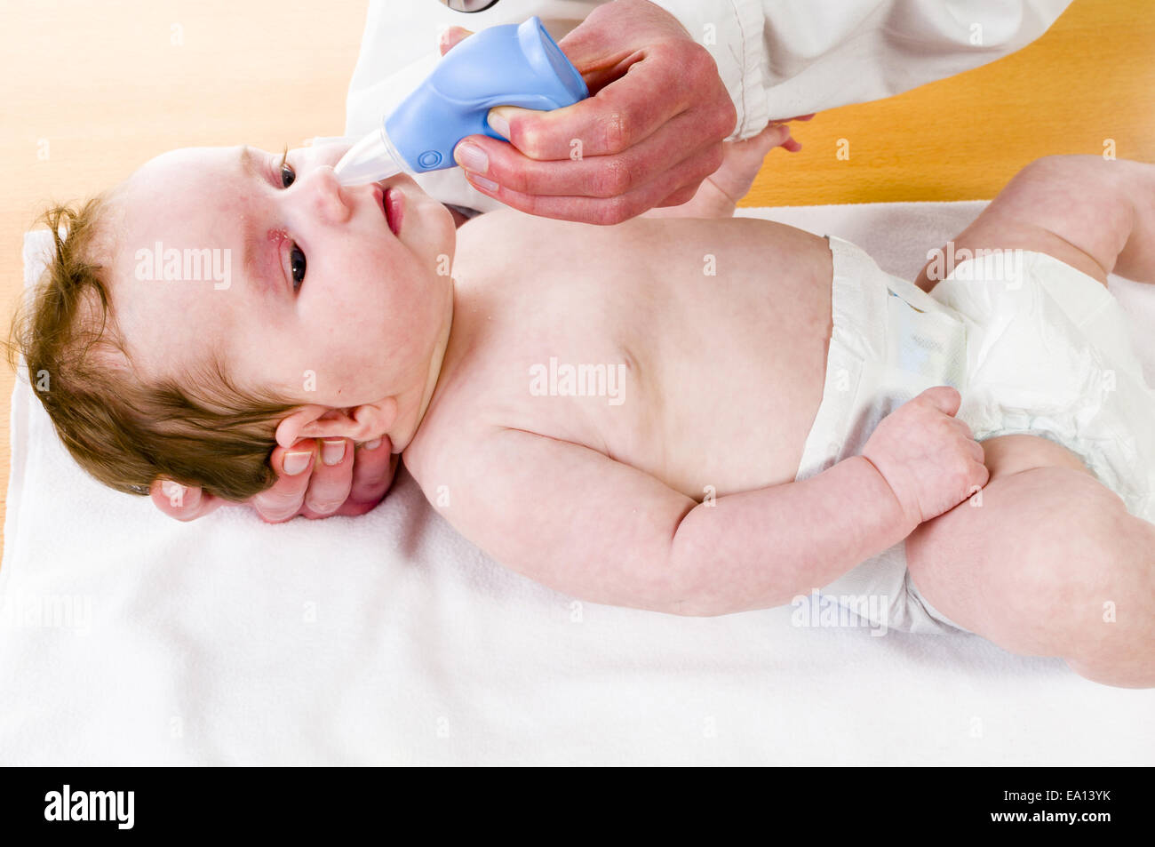 Baby with nose cleaner Stock Photo
