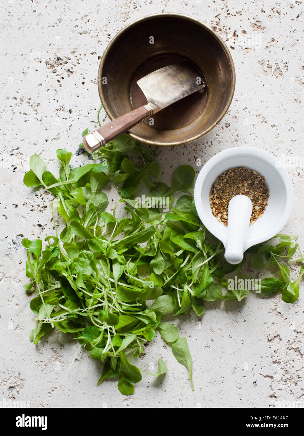 Salad leaves, chopper and pestle and mortar with spices Stock Photo