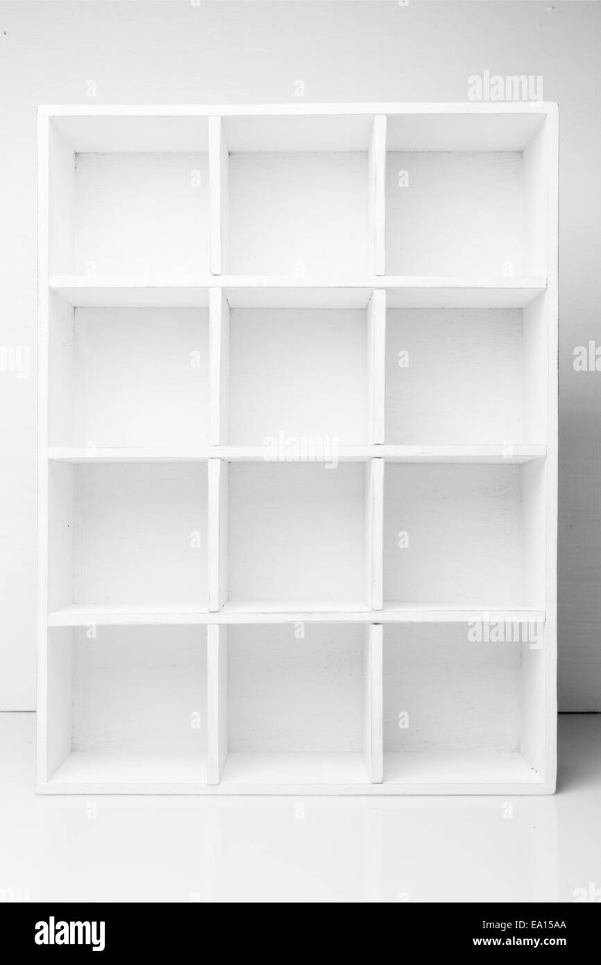 Empty Shelves in the white wooden rack Stock Photo