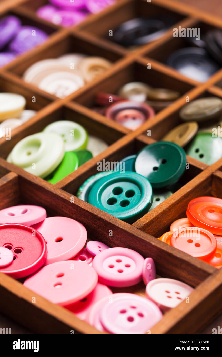 Colorful buttons in a wooden box for design Stock Photo - Alamy