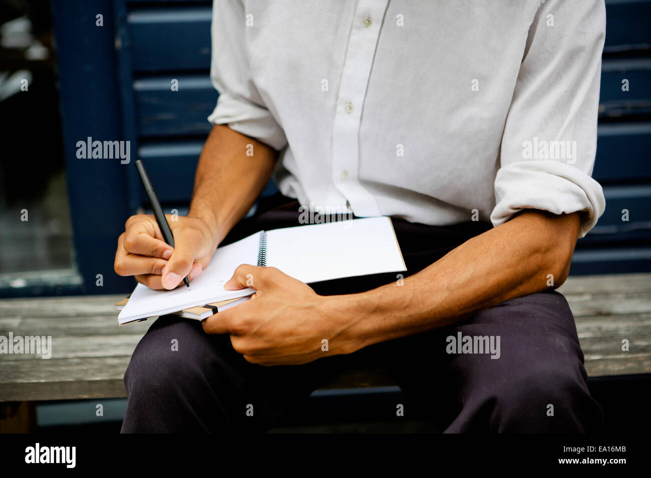 Man writing in notebook Stock Photo