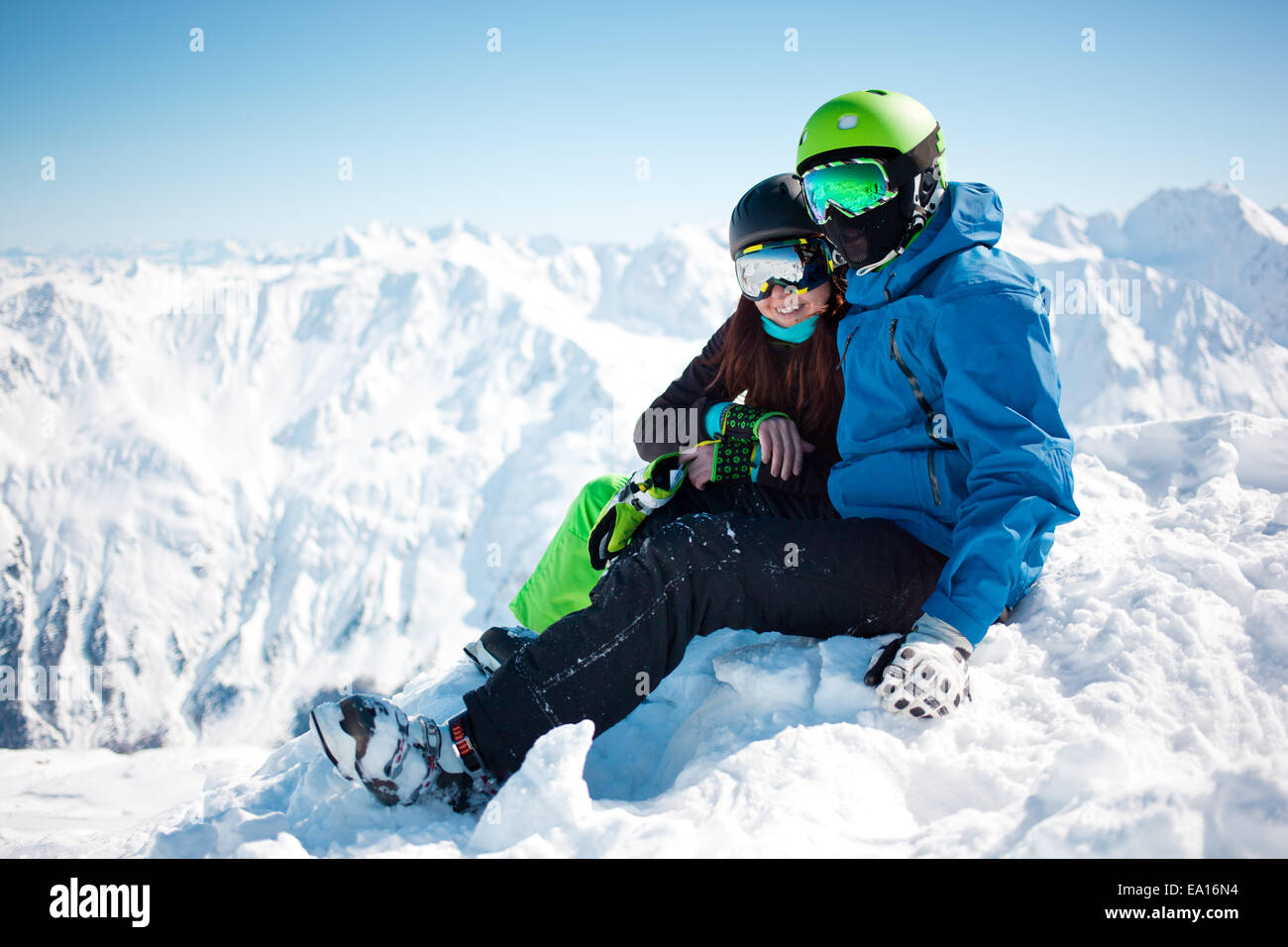Young happy couple in snowy mountains Stock Photo - Alamy