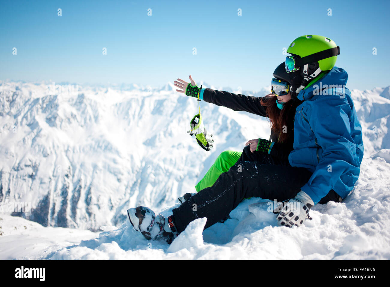 Young happy couple in snowy mountains Stock Photo - Alamy