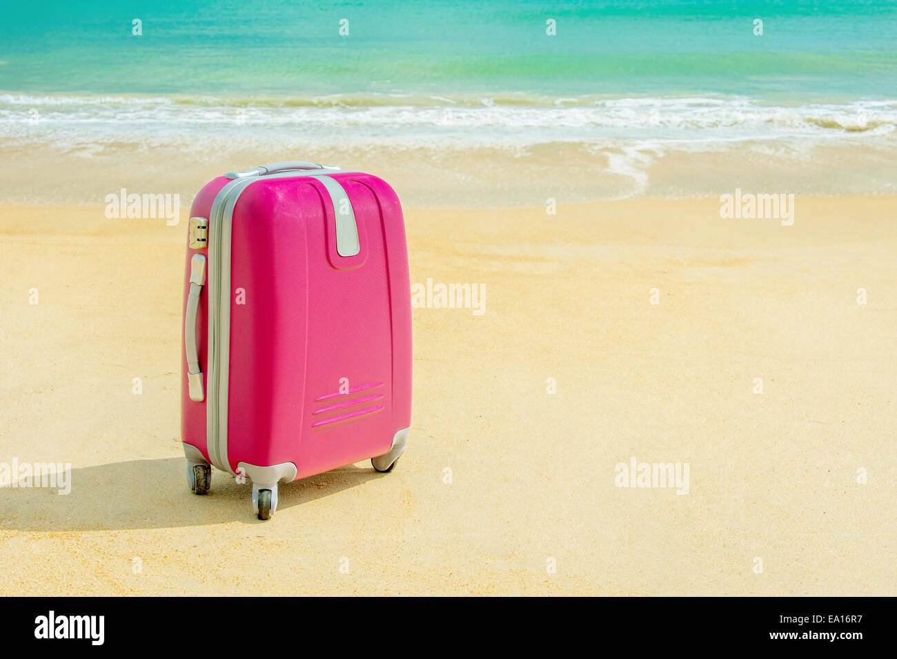 Suitcase at the sunny beach Stock Photo Alamy