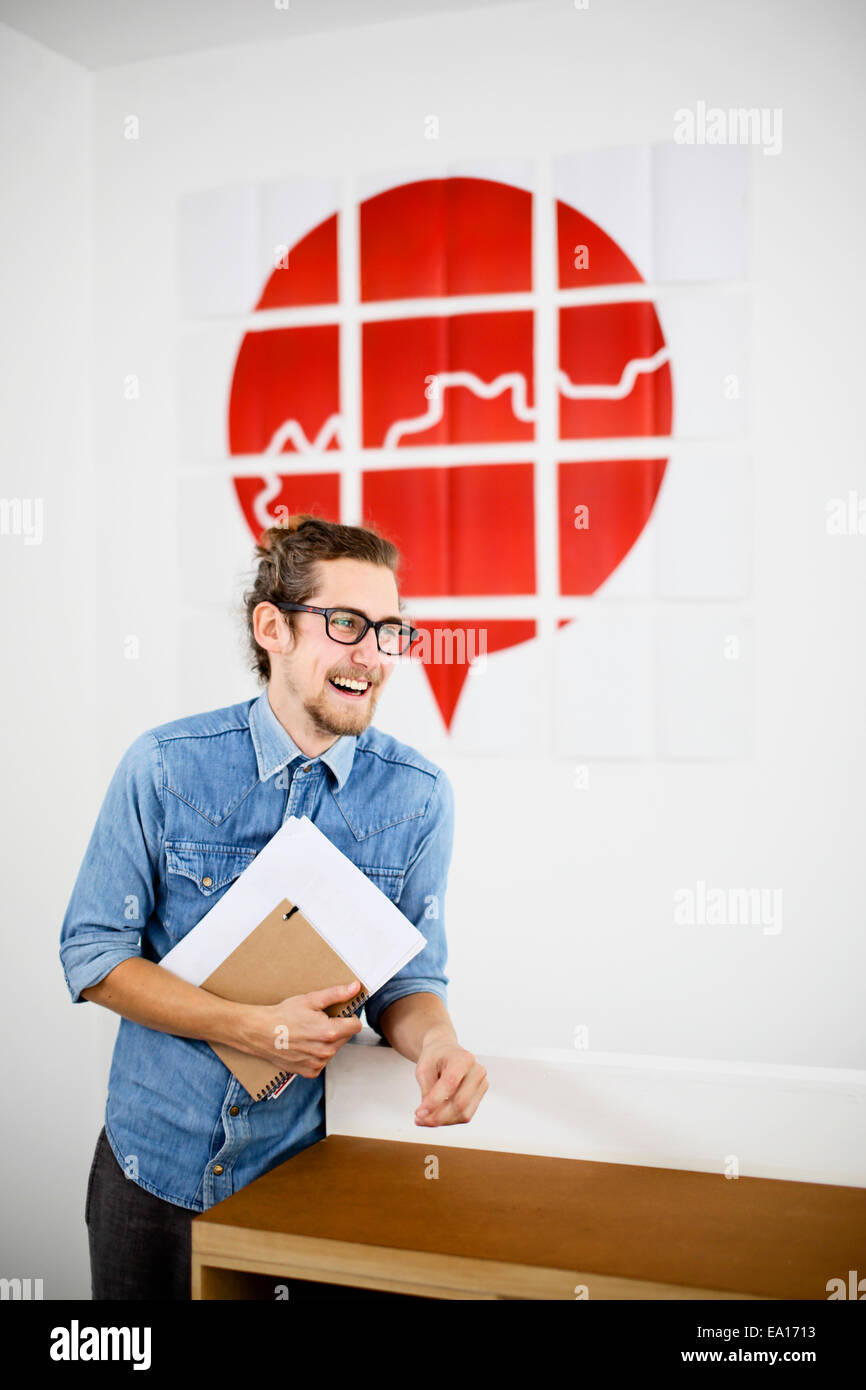 Young man in design office, smiling Stock Photo