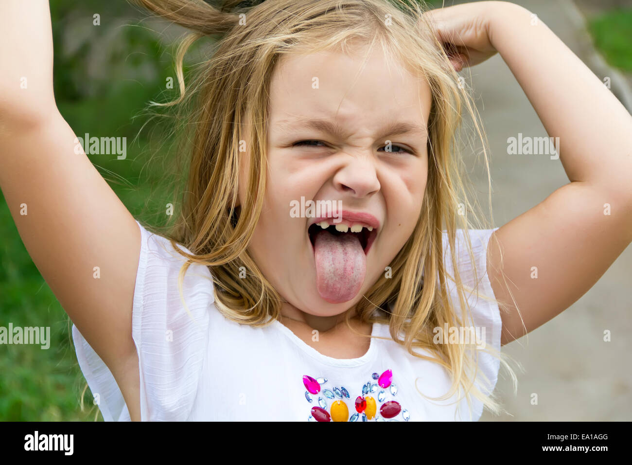 Girl makes faces imitate witch Stock Photo