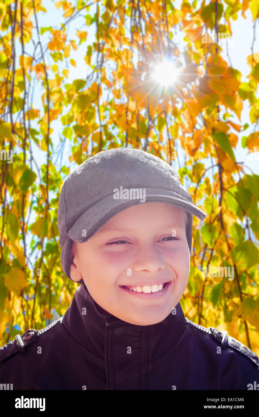 child boy happy smile sun shine autumn leaves backlight Stock Photo