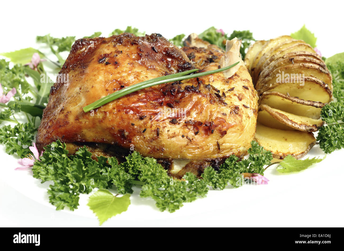 Fried chicken thighs with roast potatoes hasselback Stock Photo Alamy