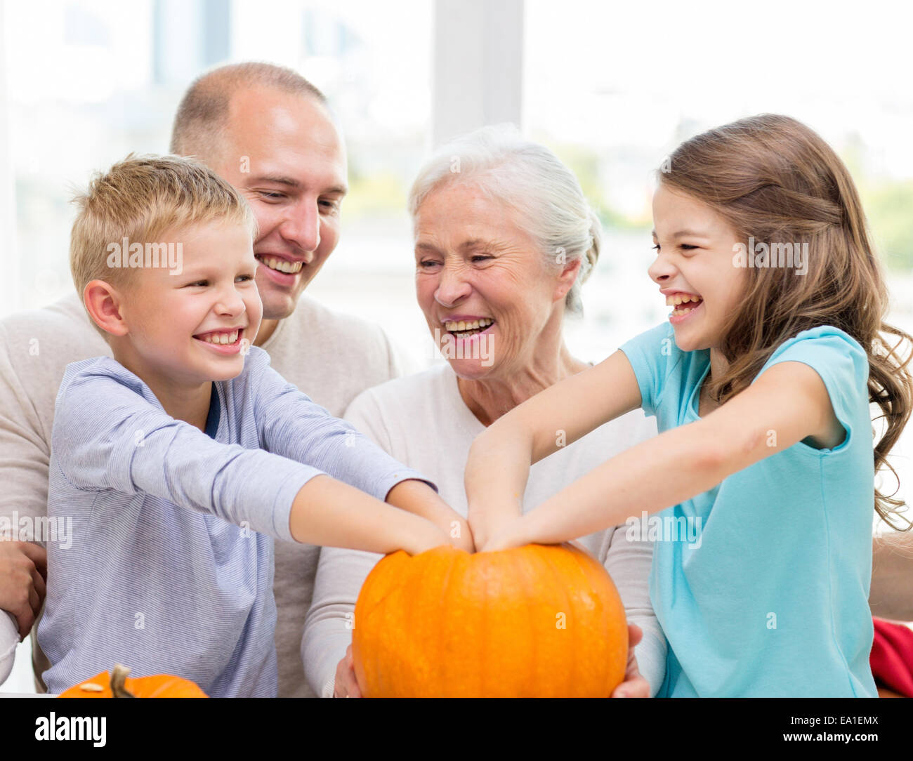 Happy Family Sitting With Pumpkins At Home Stock Photo Alamy   Happy Family Sitting With Pumpkins At Home EA1EMX 