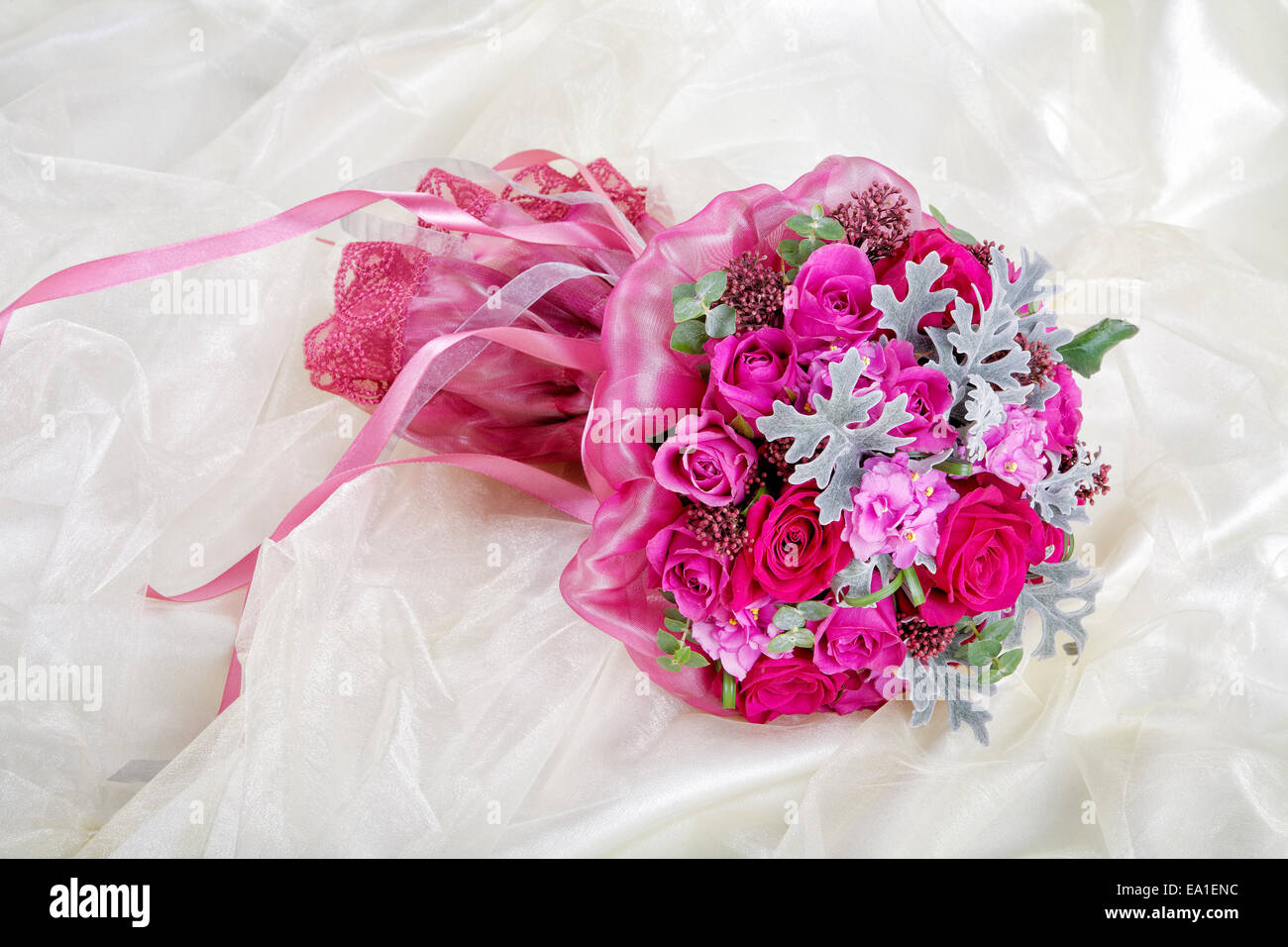 Purple wedding bouquet on a brilliant fabric Stock Photo