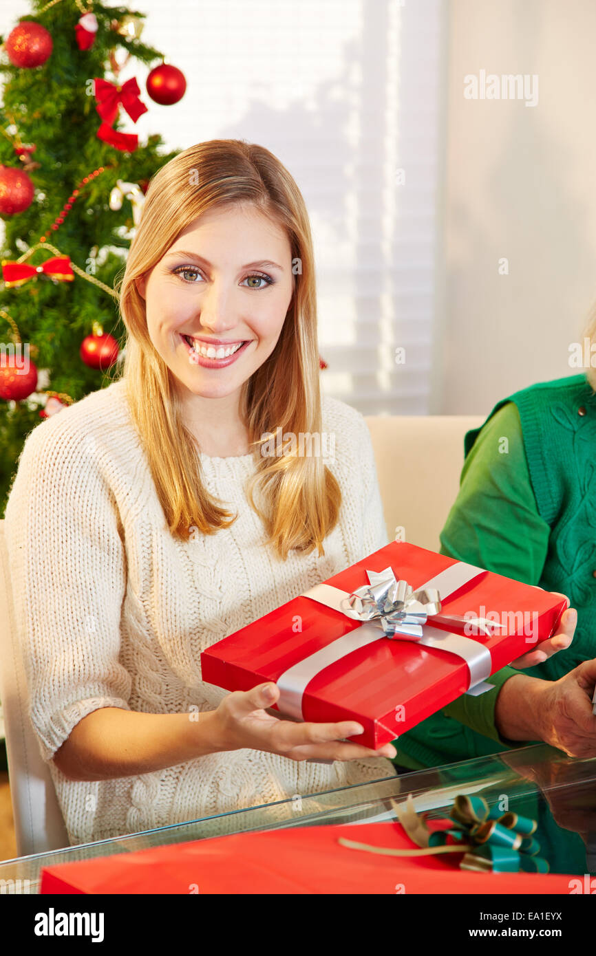 Happy woman on christmas eve with a red gift Stock Photo