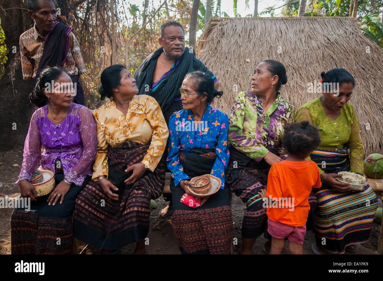 Women having conversation with a man in the traditional village of Lewotolok on the slope of Lewotolok volcano in Lembata Island, Indonesia. Stock Photo