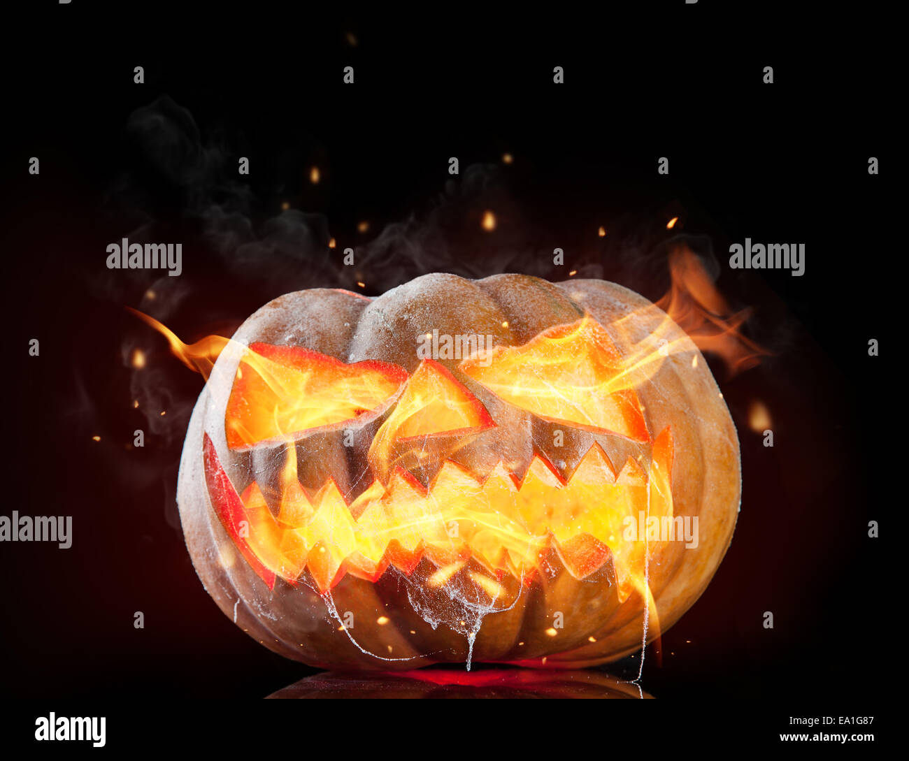 Halloween pumpkin with fire flames isolated on black background Stock Photo