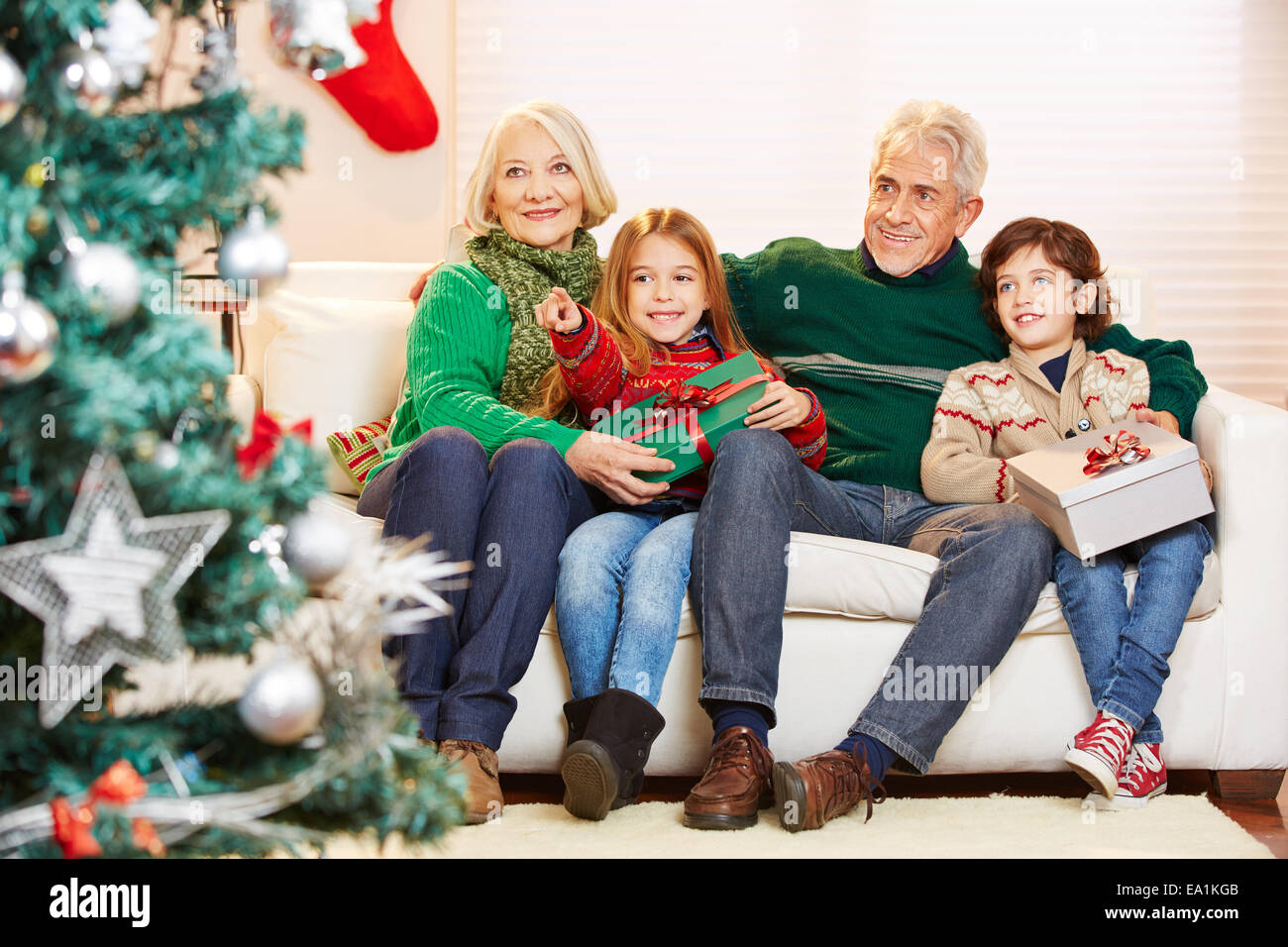 Grandparents celebrating christmas with their two grandchildren and