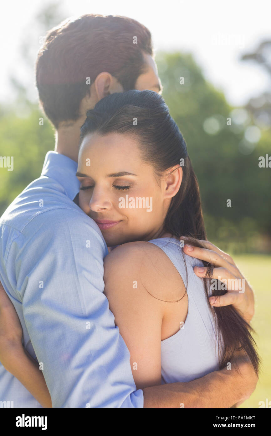Young couple embracing at park Stock Photo - Alamy