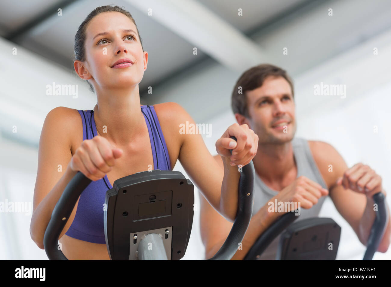 Smiling couple working out at spinning class Stock Photo - Alamy