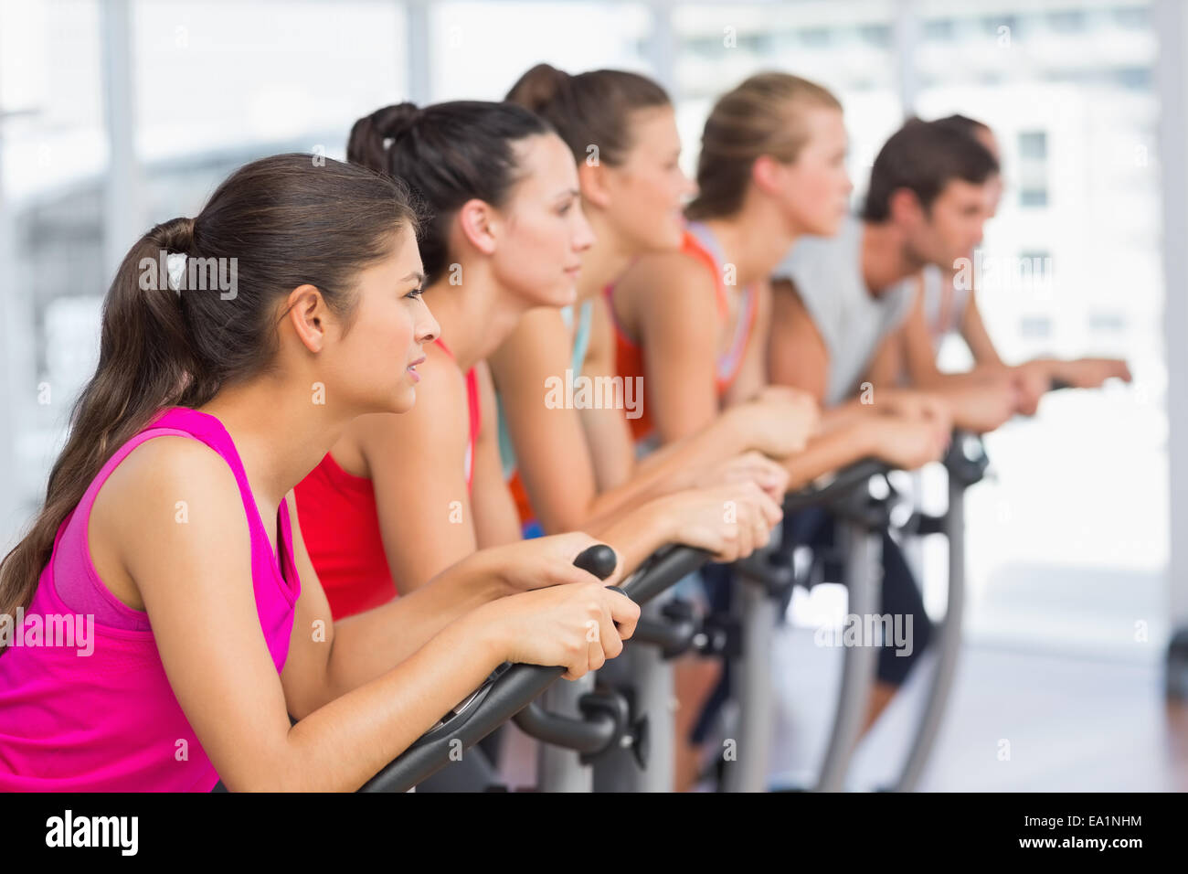 Fit people working out at spinning class Stock Photo - Alamy