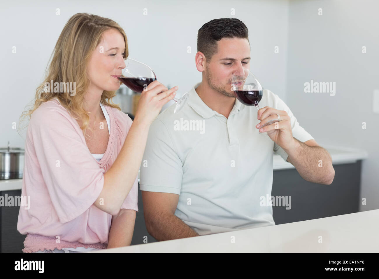 Couple drinking red wine at table Stock Photo - Alamy