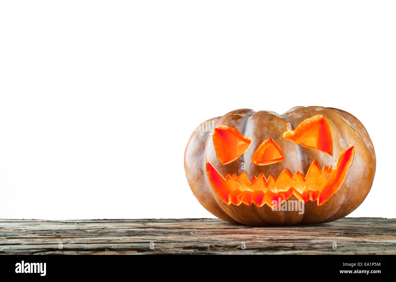 Spooky halloween pumpkin on wooden planks, isolated on white background Stock Photo