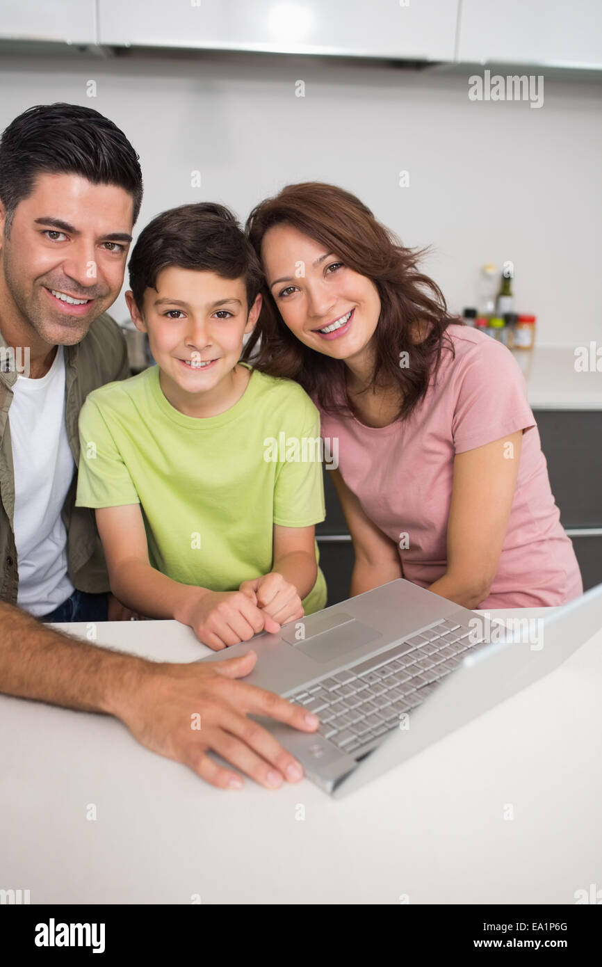 Smiling couple with son using laptop Stock Photo - Alamy