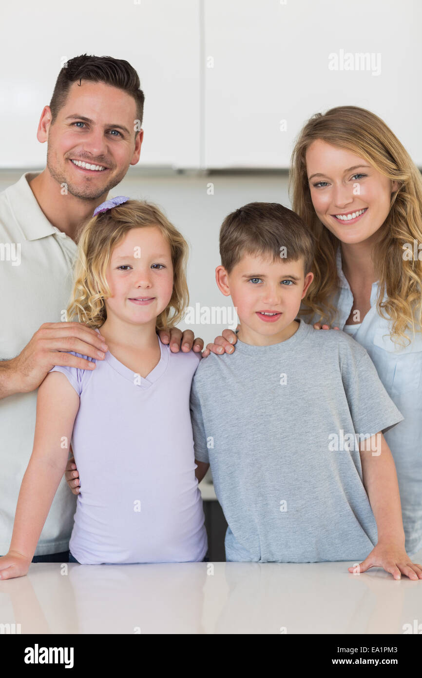 Happy family standing together in kitchen Stock Photo Alamy